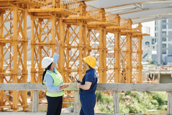 Construction workers reviewing plans on a Washington job site
