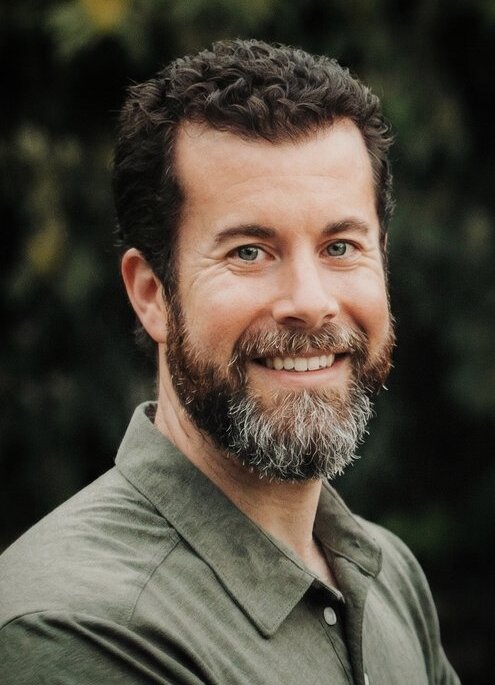 Taylor Clouse, Owner of Next Level Books, smiling outdoors
